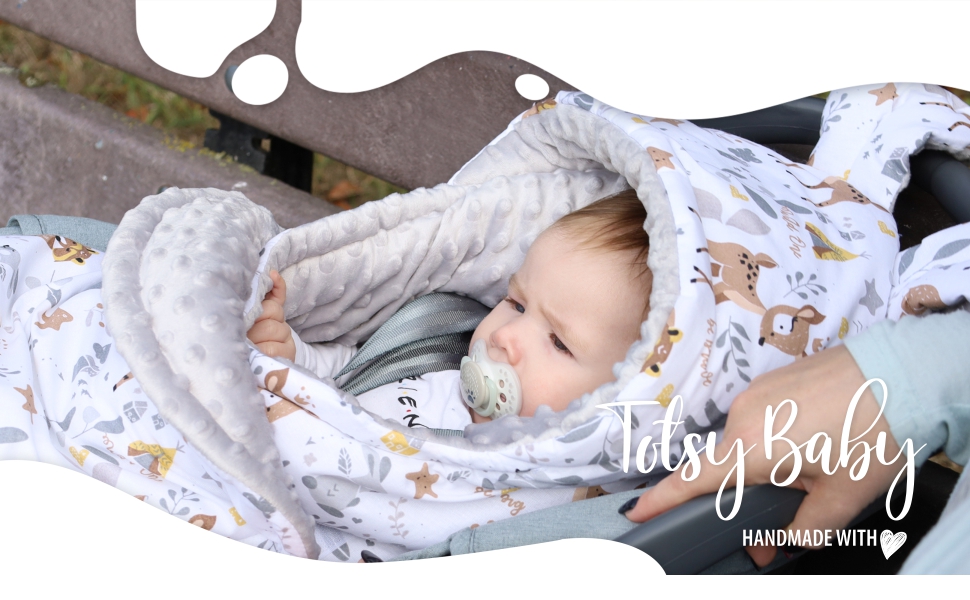 baby in a stroller with a baby blanket
