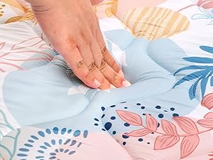 Floral pastel backdrop with leaf patterns in soft pink and blue tones, featuring delicate botanical illustrations and circular motifs.