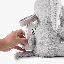 a baby's stuffed elephant is hanging on a crib.