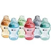 Comprehensive set of baby bottle accessories including multiple clear bottles, nipples, cleaning brushes, and storage components laid out in display format.