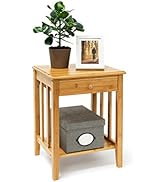 Wooden ladder shelf with four tiers, leaning against a wall. Shelves display a potted plant, framed picture, decorative items, and storage boxes.