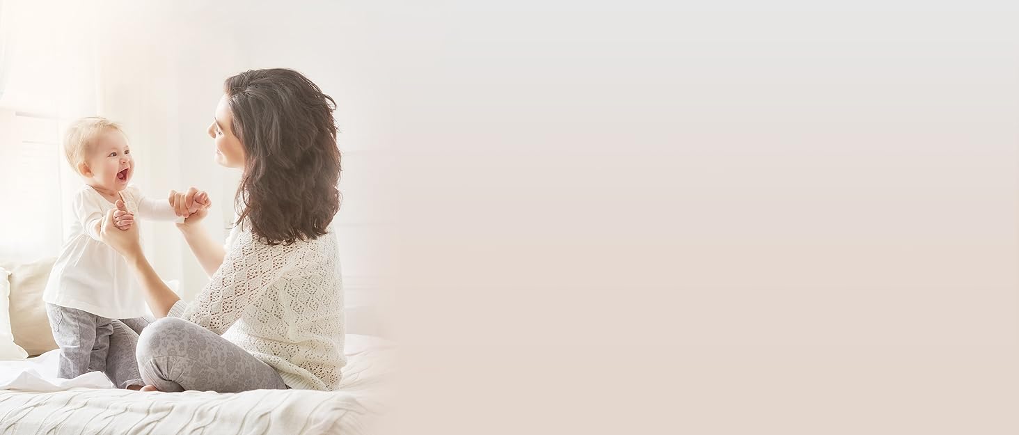 a woman sitting on a bed with her back to the camera.