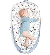 Baby carrier in light blue with rainbow pattern design. Features ergonomic design with padded shoulder straps and waist support. Front-carrying position demonstrated.