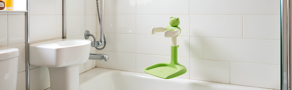 White bathroom interior showing a raised toilet platform with green accessories, featuring built-in storage solutions and modern fixtures.
