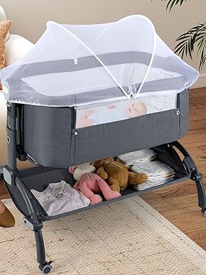 Portable bedside bassinet with grey frame, white mesh sides, and storage shelf underneath, positioned next to living room furniture.