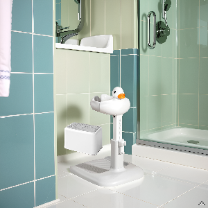 Modern bathroom interior with mint green tile walls, showing toilet paper holder and bathroom accessories mounted on wall near shower area.