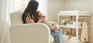 Plush or stuffed toy giraffe with detailed spotted pattern in tan and brown colors, standing pose with long neck.