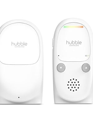 Two white compact devices - left unit is plain cylindrical, right unit features control buttons and speaker grille for audio output.
