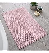 Pink bed skirt or dust ruffle shown from multiple angles, displaying gathered fabric detail and floor-length drop. Styled in bedroom setting.