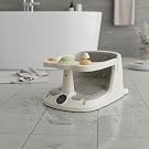 White porcelain dish holder with small vessel inside placed on bathroom sink counter. Minimalist soap or accessory storage container.