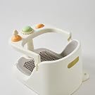 White ceramic container with small rubber duck toy resting on edge against textured gray surface. Multiple angles showing circular dish design.