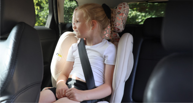 Interior of a vehicle showing car seats with passengers. Focus on the seating arrangement and interior details.