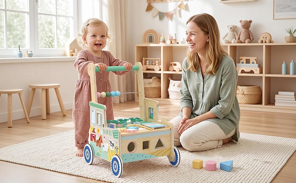 Adult and child playing with wooden push toy cart containing colorful shape-sorting blocks in home playroom setting with natural window lighting.