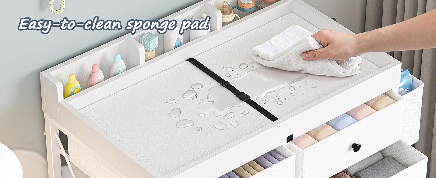 Text reads 'Changing table with multiple storage spaces' with icons for 'Diaper,' 'Clothes,' 'Skin Source,' 'Toys.' White wooden changing table with organized compartments displayed in home setting.