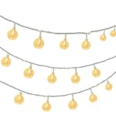 Warm golden-yellow neon LED string lights displaying Christmas motifs including stars, trees, and bells hanging against dark background.
